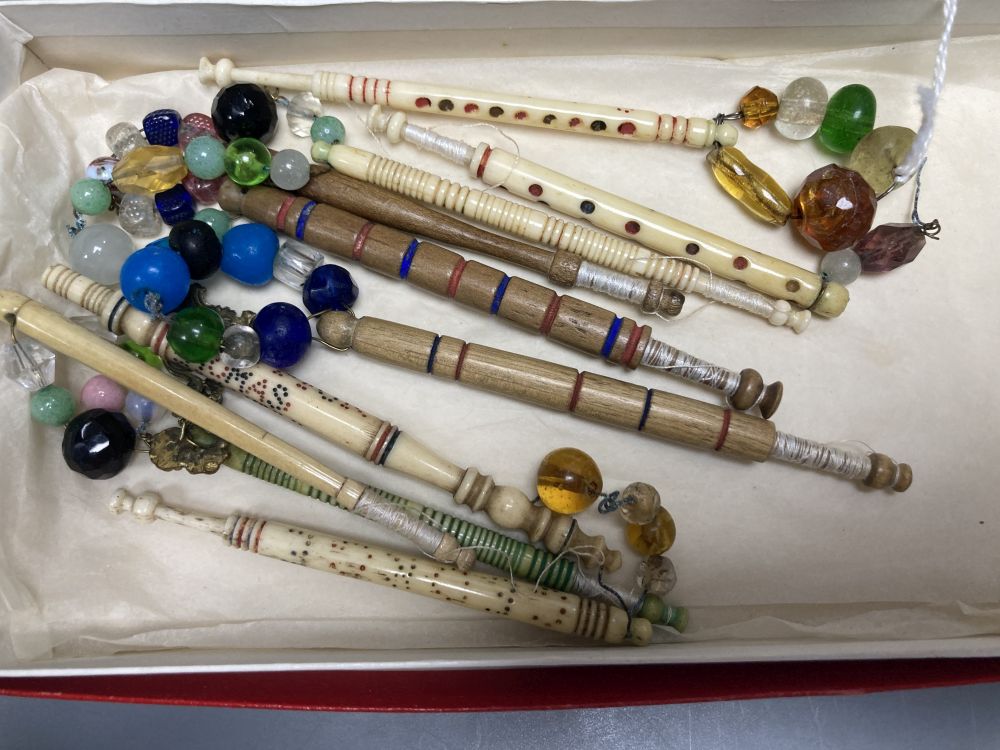 A Victorian mother of pearl-inlaid rosewood sewing box, containing various accessories, lace bobbins, etc.